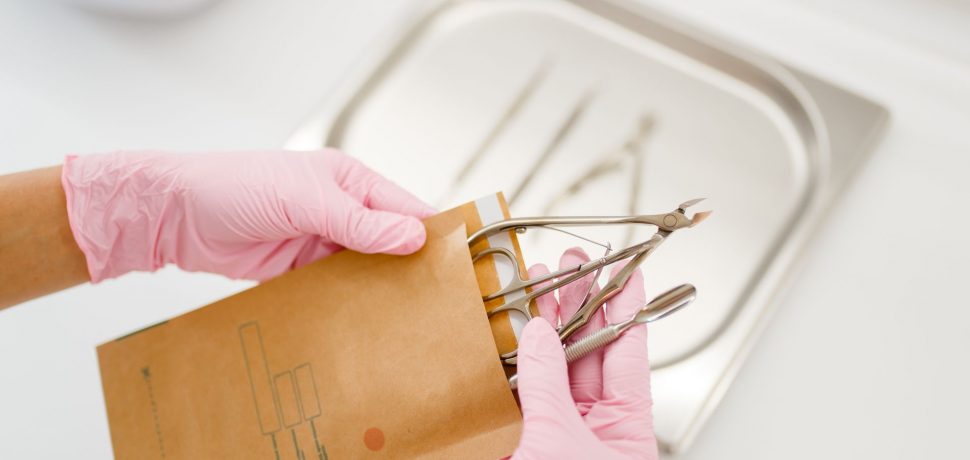 cosmetologist-in-gloves-holds-manicure-equipment-RJC3VBT.jpg