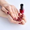 hands-of-a-woman-with-dark-red-manicure-and-nail-P5VNS4S.jpg